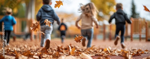 Children joyfully running through a colorful autumn landscape, playing amidst falling leaves in a park.