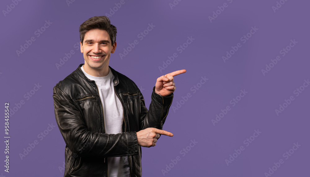 Happy promoter man presenting on workspace, mockup, promo commercial isolated on violet background. Portrait of guy, he pointing with arms on his left with copy space. Happy promoter man presenting on workspace, mockup, promo commercial isolated on violet background. Portrait of guy, he pointing with arms on his left with copy space.