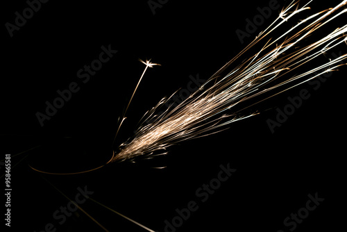 sparks from the grinder glowing in the dark