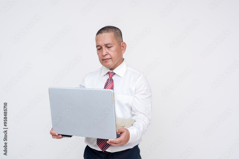 A middle aged asian manager reading a laptop held in his arms. Isolated on a white background. A middle aged asian manager reading a laptop held in his arms. Isolated on a white background.