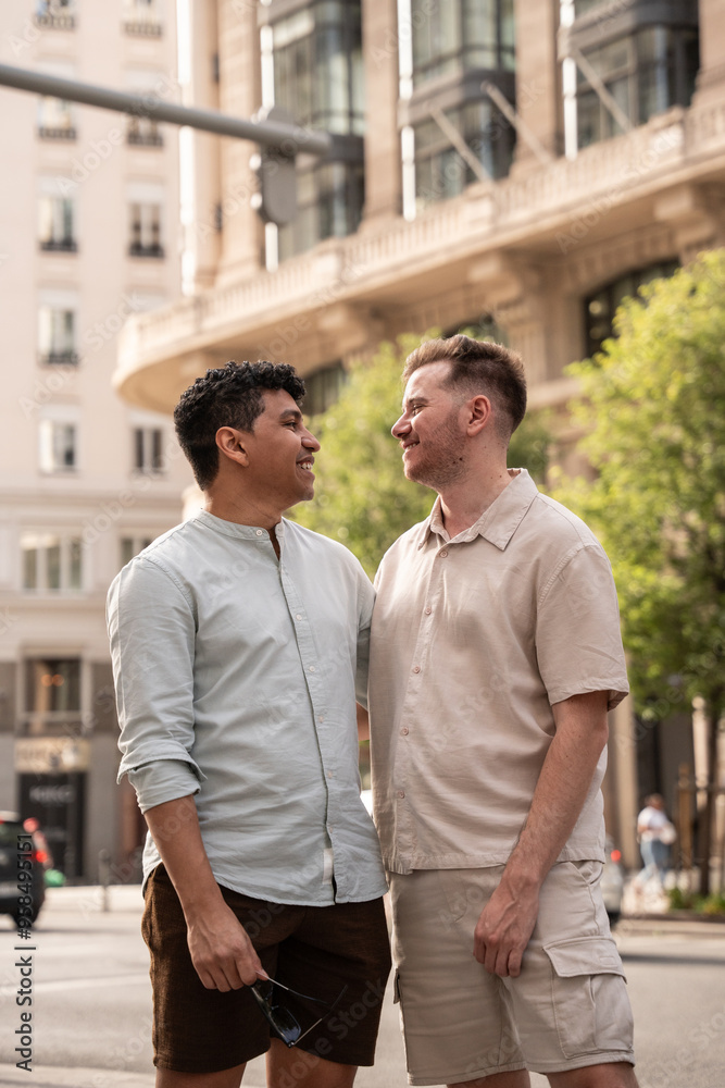 Multiethnic gay couple sharing a joyful moment in a city setting Multiethnic gay couple sharing a joyful moment in a city setting