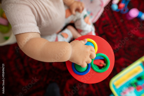 Baby playing with colorful ...