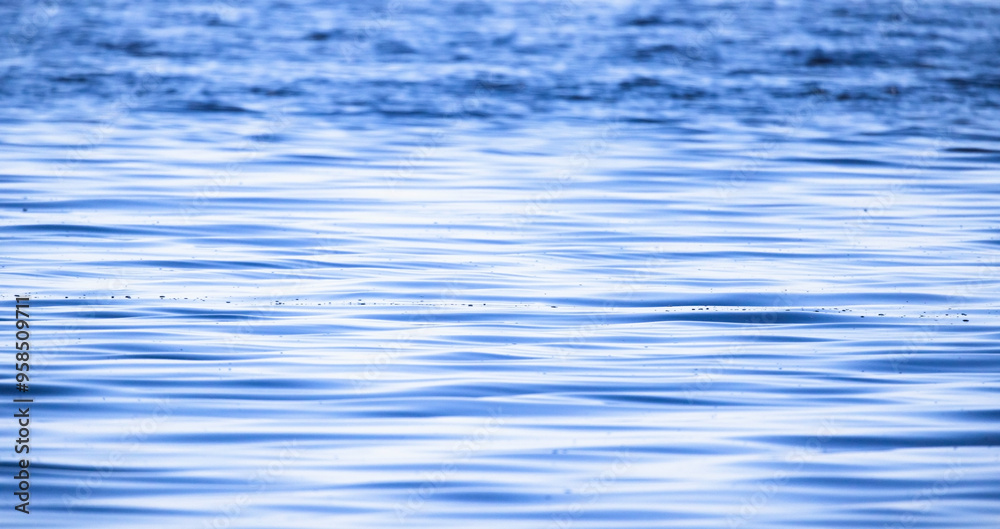 Blue water surface with soft ripple pattern, natural panoramic background Blue water surface with soft ripple pattern, natural panoramic background