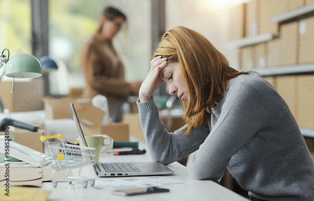 Exhausted woman with headache in the office Exhausted woman with headache in the office