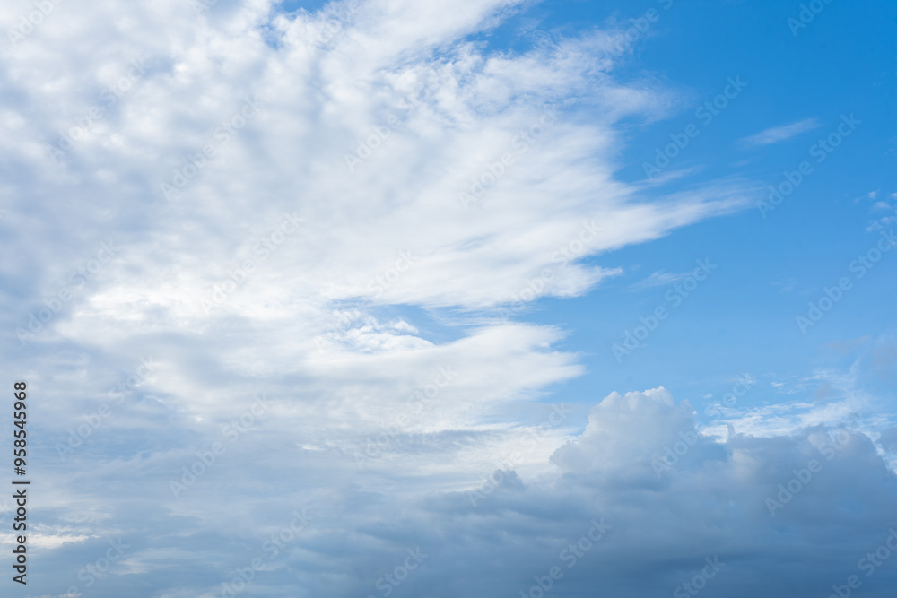 Fluffy white clouds drift across a bright blue sky, painting a beautiful summer day Fluffy white clouds drift across a bright blue sky, painting a beautiful summer day