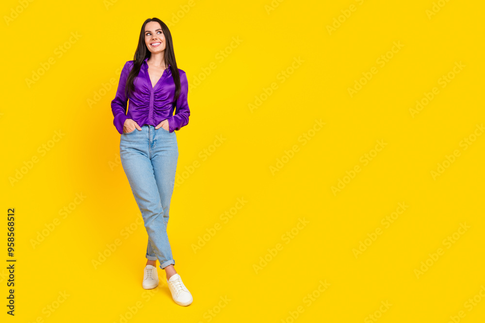Photo of positive smiling lady look empty space hold hands pockets isolated bright color background Photo of positive smiling lady look empty space hold hands pockets isolated bright color background