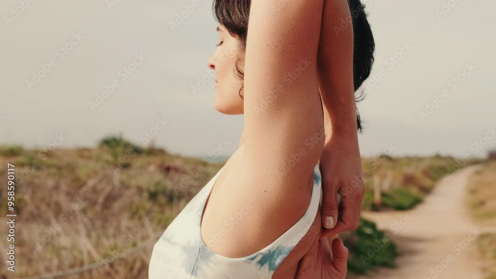 Side close-up view of a of a young woman doing yoga outdoors, stretching workout Side close-up view of a of a young woman doing yoga outdoors, stretching workout