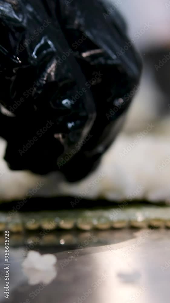 make sushi Cook's hands close-up. A chef makes sushi and rolls from rice, red fish, avocado and philadelphia cheese. step by step. make sushi Cook's hands close-up. A chef makes sushi and rolls from rice, red fish, avocado and philadelphia cheese. step by step.