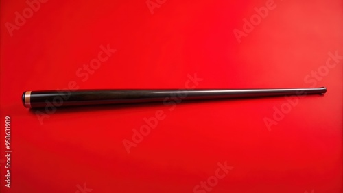 Black Wooden Pipe Stem on Red Background photo