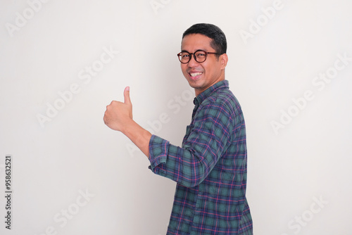 A man turned around and gave a thumbs up with a happy expression