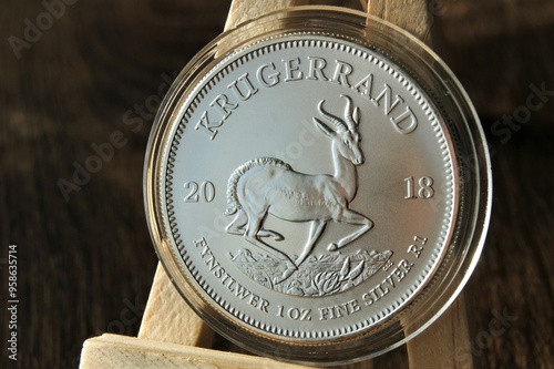 Silver investment coin in capsule. Silver Krugerrand 1 Rand 2018 South Africa. Close up.