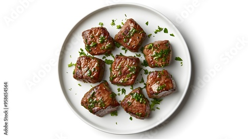 Grilled beef medallions with fresh herbs on white plate