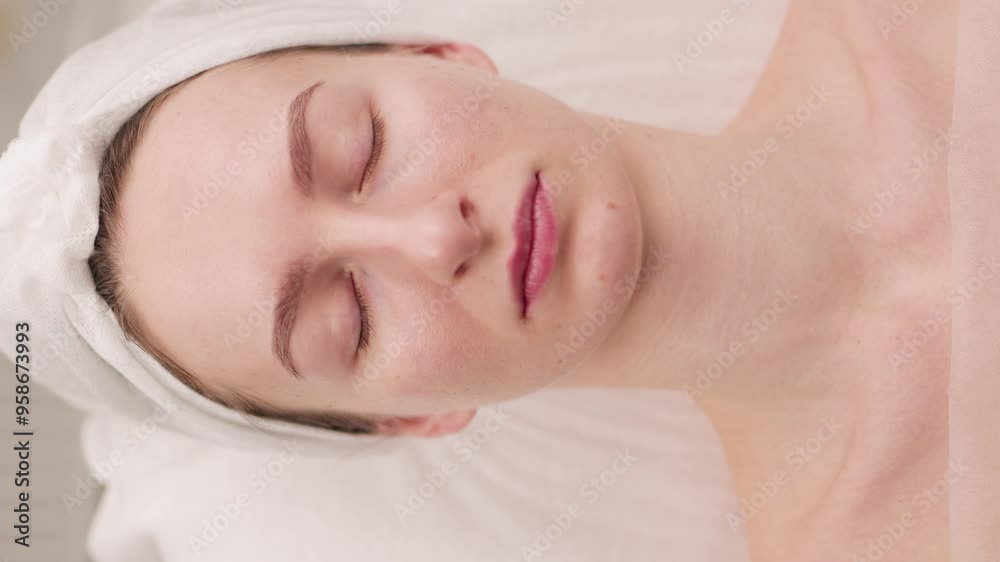 A woman massage therapist gives a girl a facial massage and cosmetic procedures. A woman massage therapist gives a girl a facial massage and cosmetic procedures.