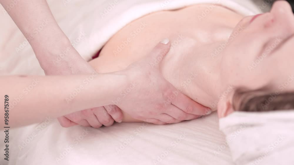 A woman massage therapist gives a girl a facial massage and cosmetic procedures. A woman massage therapist gives a girl a facial massage and cosmetic procedures.