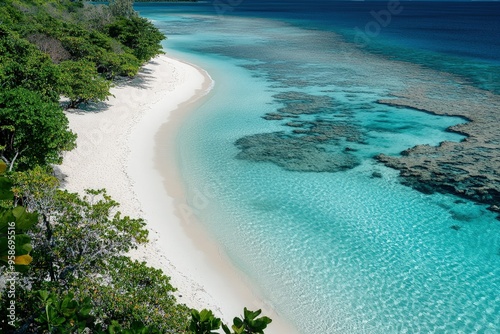 an aerial view of a sandy beach and clear blue water