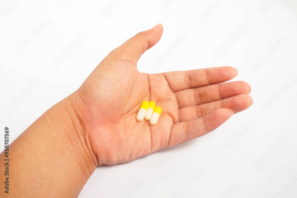 a man consuming three yellow capsules with white isolated a man consuming three yellow capsules with white isolated