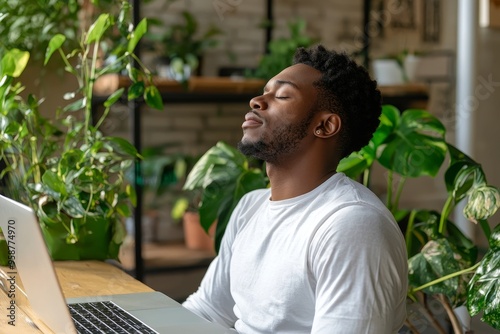 At their desk, the employee is calming their mind by doing breathing exercises