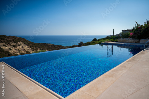 A beautiful pool at a house in a summer landscape, with a sea view in the distance.