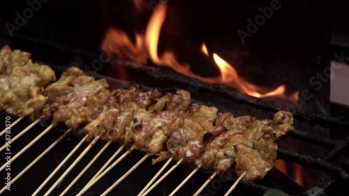 Wallpaper Mural Preparing satay pork skewers on charcoal stove. Asian BBQ , slow motion. Torontodigital.ca