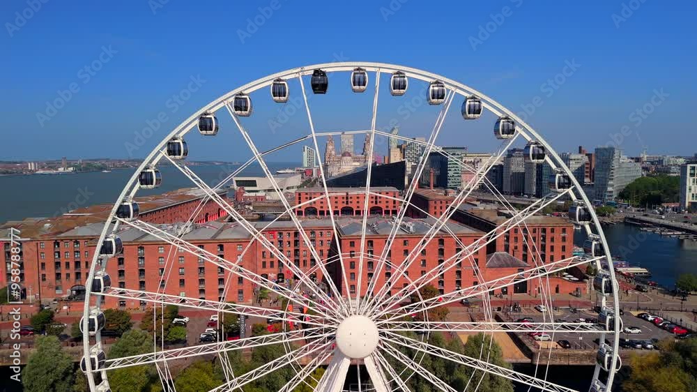 An aerial view a giant Ferris wheel overlooking the Docks and Liverpool skyline An aerial view a giant Ferris wheel overlooking the Docks and Liverpool skyline