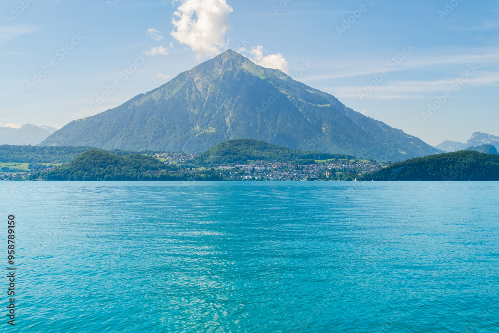 a big triangle mountain on the blue lake background a big triangle mountain on the blue lake background