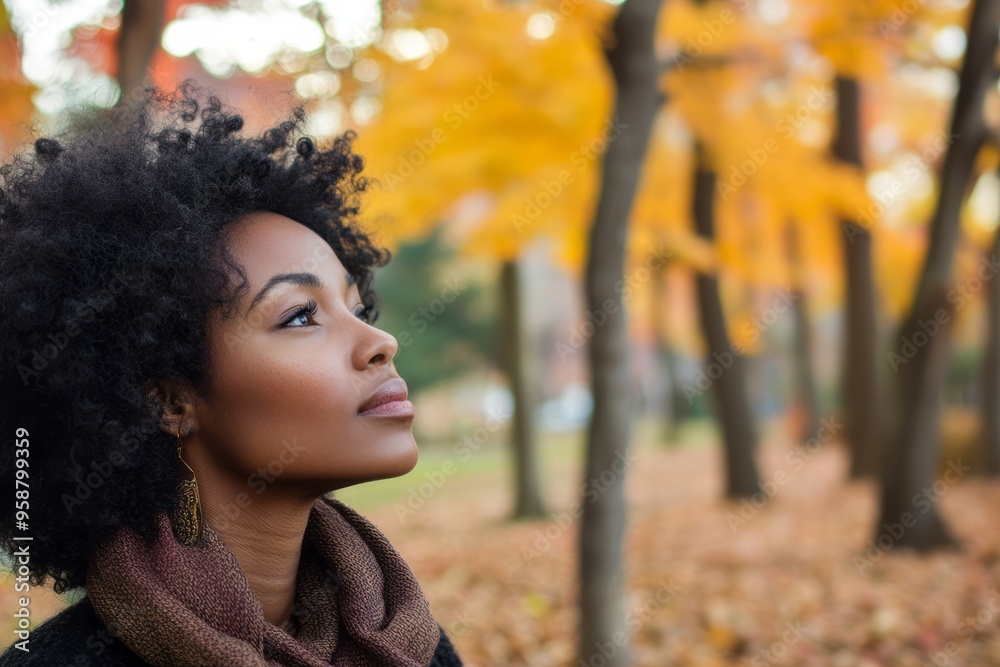 Portrait of a joyful African American woman with curly hair enjoying the autumn season Portrait of a joyful African American woman with curly hair enjoying the autumn season