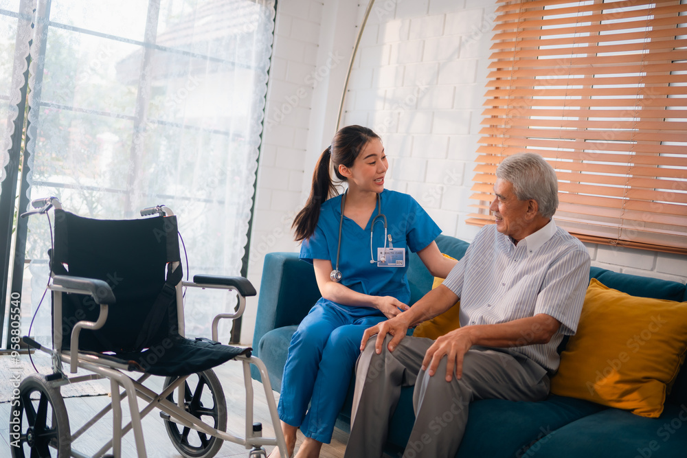 A woman in a blue uniform helps an elderly man in a wheelchair A woman in a blue uniform helps an elderly man in a wheelchair
