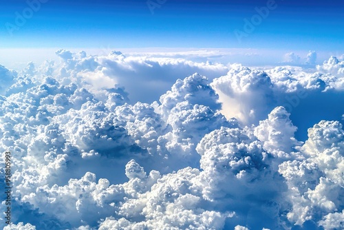 Beautiful aerial view of fluffy white clouds against a bright blue sky, perfect for nature and travel themes.