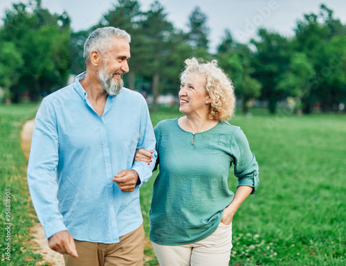 woman man mature couple happy together active bonding park outdoor middle aged talking leisure park fun smiling love old middle mid aged nature wife walking