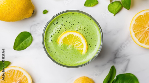 Refreshing green matcha lemon served in a glass, garnished with lemon slices and surrounded by fresh lemons and leaves photo