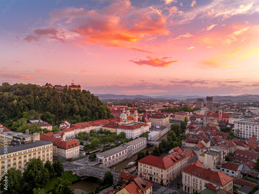 Aerial view of central Ljubljana Slovenia with historic buildings, hilltop castle red roof houses, churches in the Slovenian capital sunset colorful sky