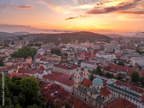 Aerial view of central Ljubljana Slovenia with historic buildings, hilltop castle red roof houses, churches in the Slovenian capital sunset colorful sky