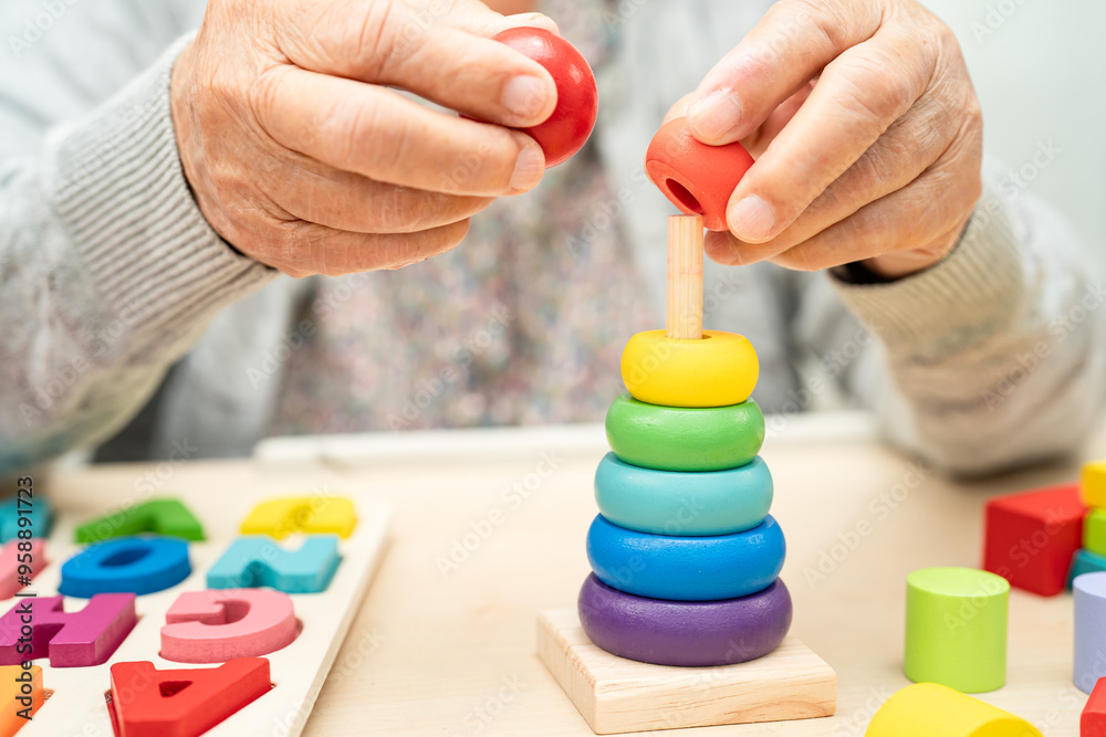 Alzheimer disease AD, Asian senior woman patient suffering from dementia learn practical motor skills rehabilitation. Alzheimer disease AD, Asian senior woman patient suffering from dementia learn practical motor skills rehabilitation.