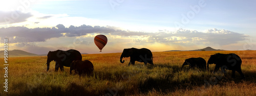 Herd of African elephants in the savannah and balloon. Africa. Tanzania. photo