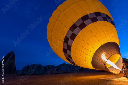 Filling up a yellow hot air balloon in Cappadocia, Turkey.