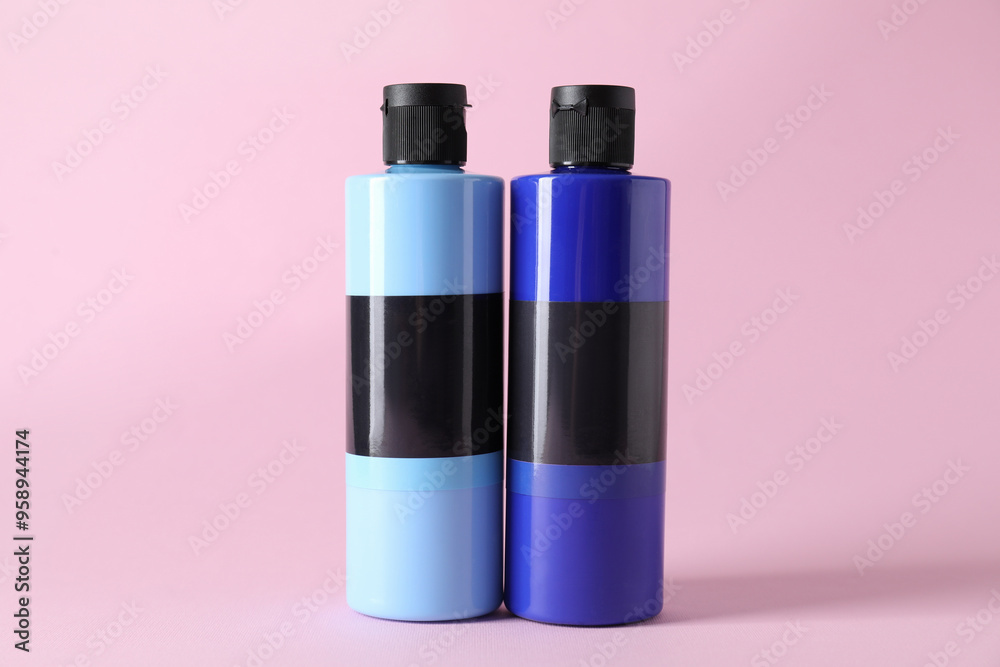 Acrylic paints of different colors on pink background Acrylic paints of different colors on pink background