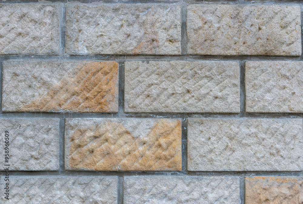 Naklejka premium Textured Stone Wall Rustic Beige Warm Colors Geometric Patterns Durable Building Material