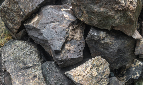 A pile of large stones during the rain. Big wet rocks close-up