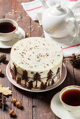 Obraz na płótnie Tea party with Black Forest cake. Cherry cake decorated with chocolate fir trees on a light background. w salonie