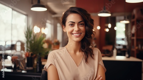 Confident beauty salon owner in a tan shirt standing proudly with arms crossed. Perfect for showcasing professionalism and success in the beauty industry or small business ownership.
