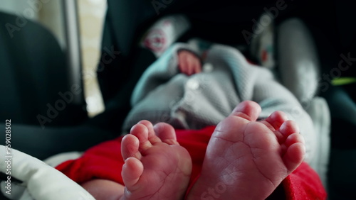 Relaxed baby in car seat, focus on tiny feet, soft and tender toes, cozy and calm atmosphere, detailed view of newborn’s feet, intimate and peaceful moment of rest, comfortable and serene