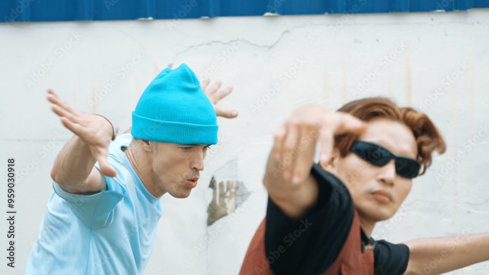 Closeup of hipster group dancing street dance together at wall. Young break dancer team practicing break dance, moving to modern rhythm, express feeling of lively. Outdoor sport 2024. Hiphop. Closeup of hipster group dancing street dance together at wall. Young break dancer team practicing break dance, moving to modern rhythm, express feeling of lively. Outdoor sport 2024. Hiphop.