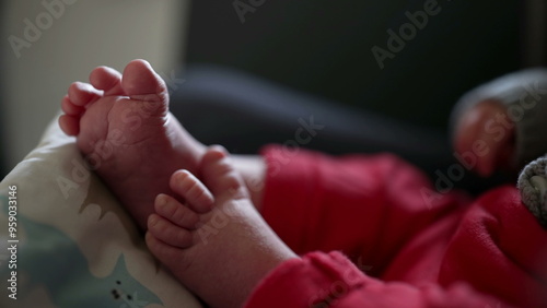 Tiny baby feet, close-up view of infant toes, baby lying on patterned cushion, relaxed and cozy atmosphere, detailed and intimate shot of newborn feet, peaceful and tender moment photo