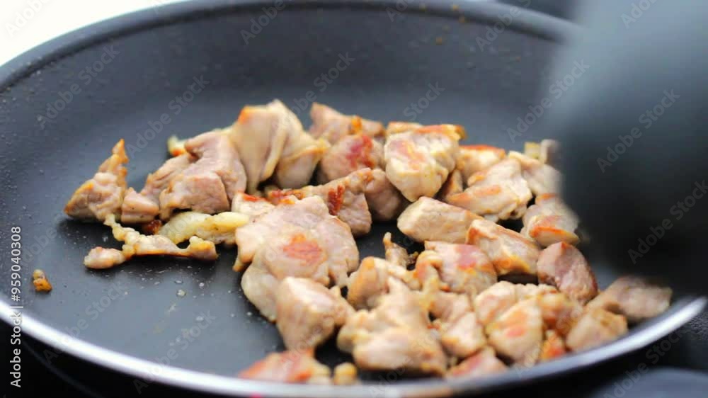 Delicious pieces of a juicy pork tenderloin being cooked on kitchen pan. Delicious pieces of a juicy pork tenderloin being cooked on kitchen pan.