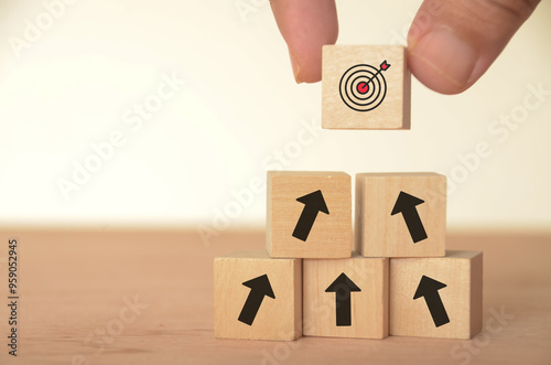 The image of a target block atop arrows suggests a clear path toward achieving goals. photo