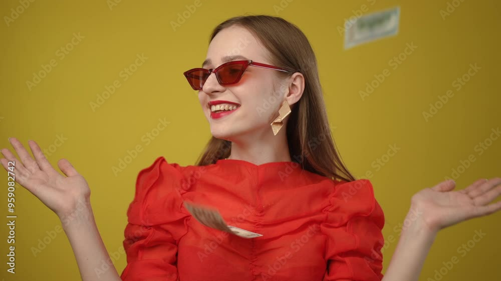 A stylish woman poses confidently in a vibrant red dress against a bright yellow background that pops