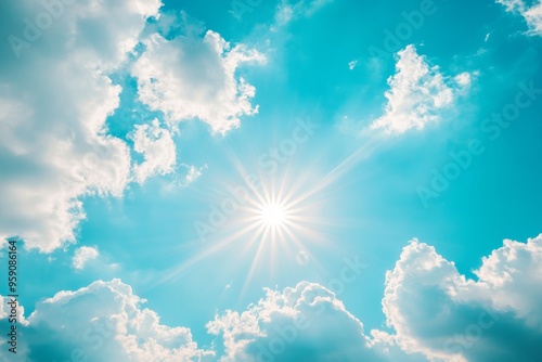 A picturesque scene showcasing a bright sun illuminating fluffy clouds against a serene blue sky while embodying the tranquility and undeniable beauty of nature in its full glory and splendor