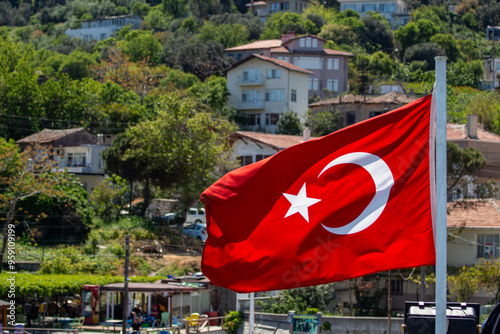 Turkish flag waving in the wind. Turkish flag waving in the wind on the background of the city.
