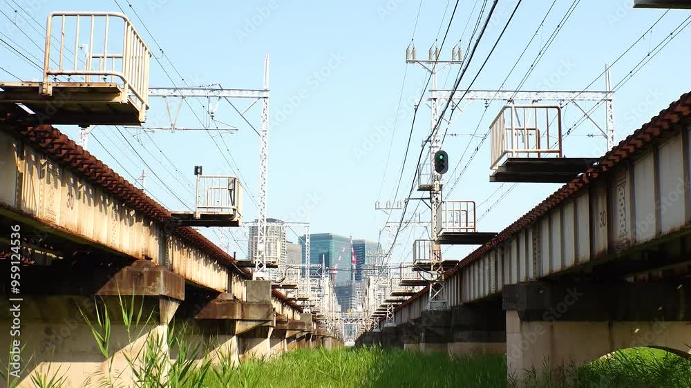 OSAKA, JAPAN - JUNE 2024 : View of train passing at Juso Ohashi bridge and buildings around Osaka station. Time lapse shot in daytime. OSAKA, JAPAN - JUNE 2024 : View of train passing at Juso Ohashi bridge and buildings around Osaka station. Time lapse shot in daytime.