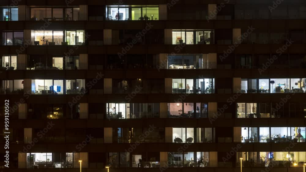 Nighttime time-lapse of a close-up view of building windows. Ideal for projects focused on urban life, cityscapes, and modern living.